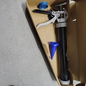 Black and Silver Caulking Gun with Blue Accessories